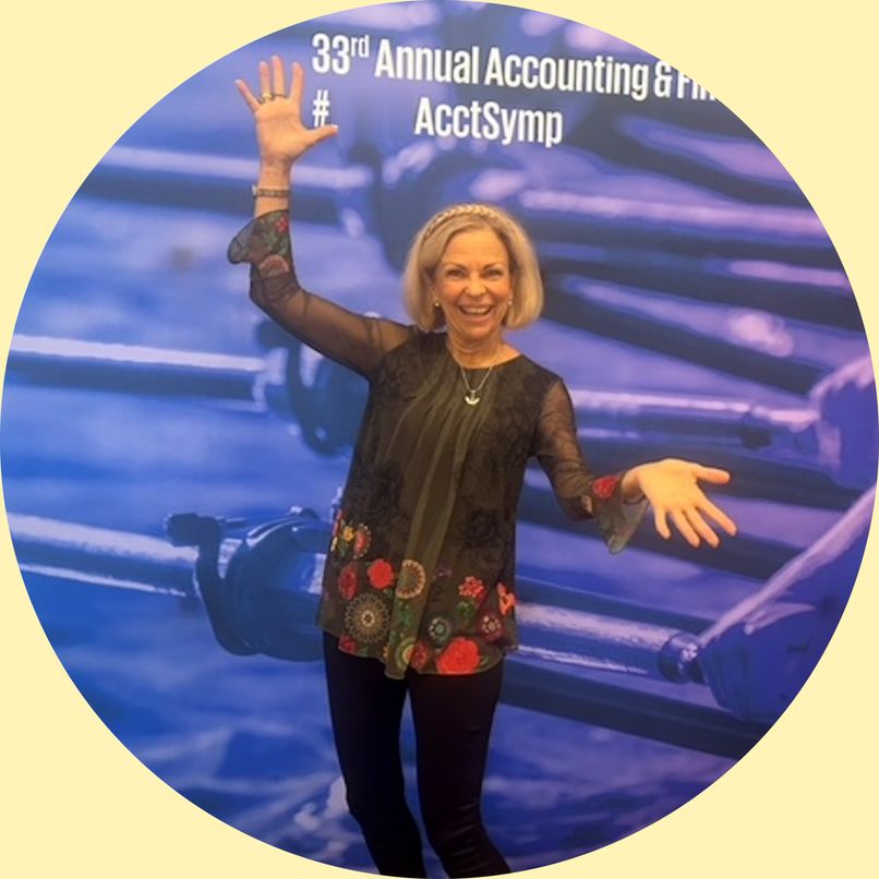 Amanda Gore, leadership speaker, smiling with her arms out wide at a conference